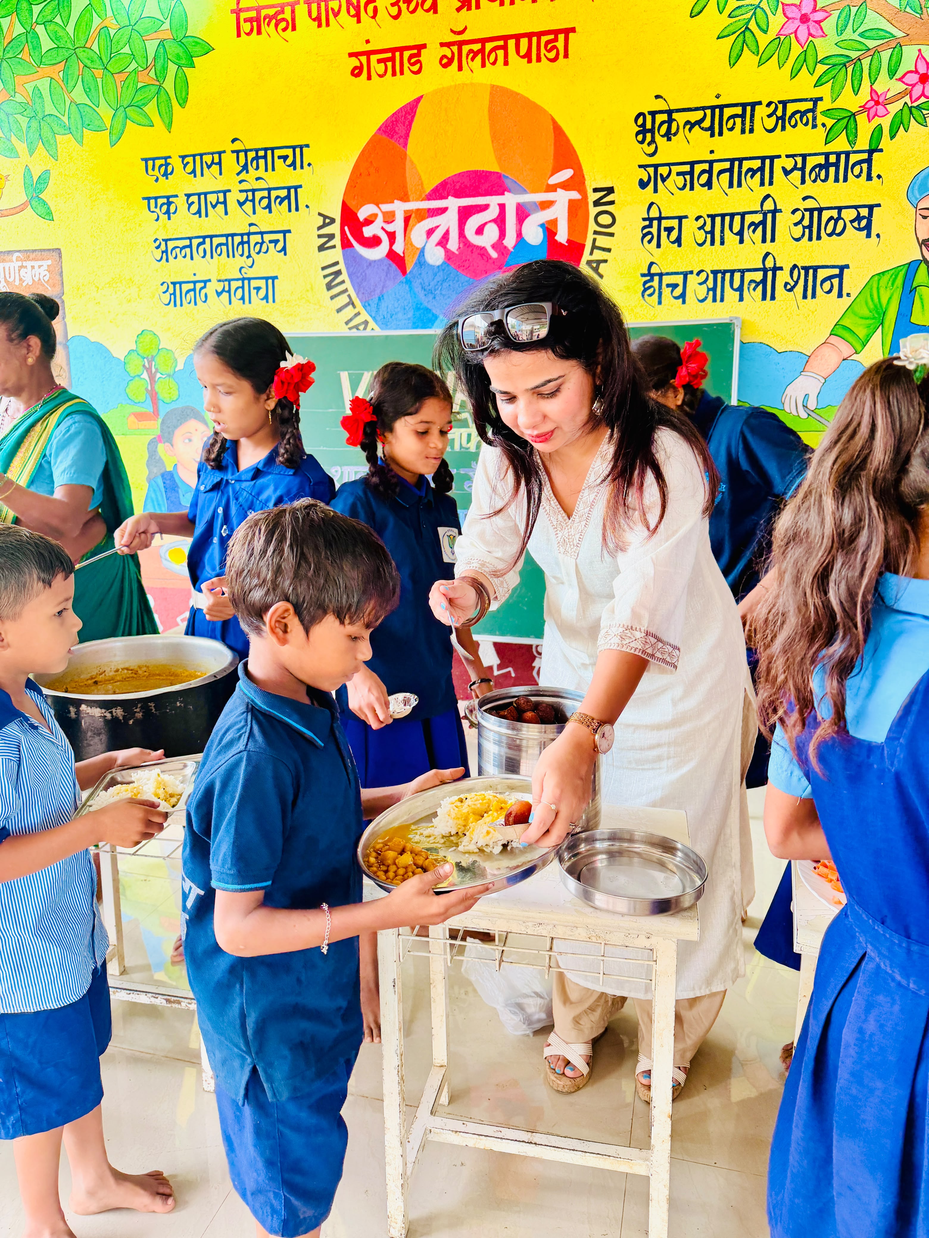 Woman serving meals to schoolchildren
