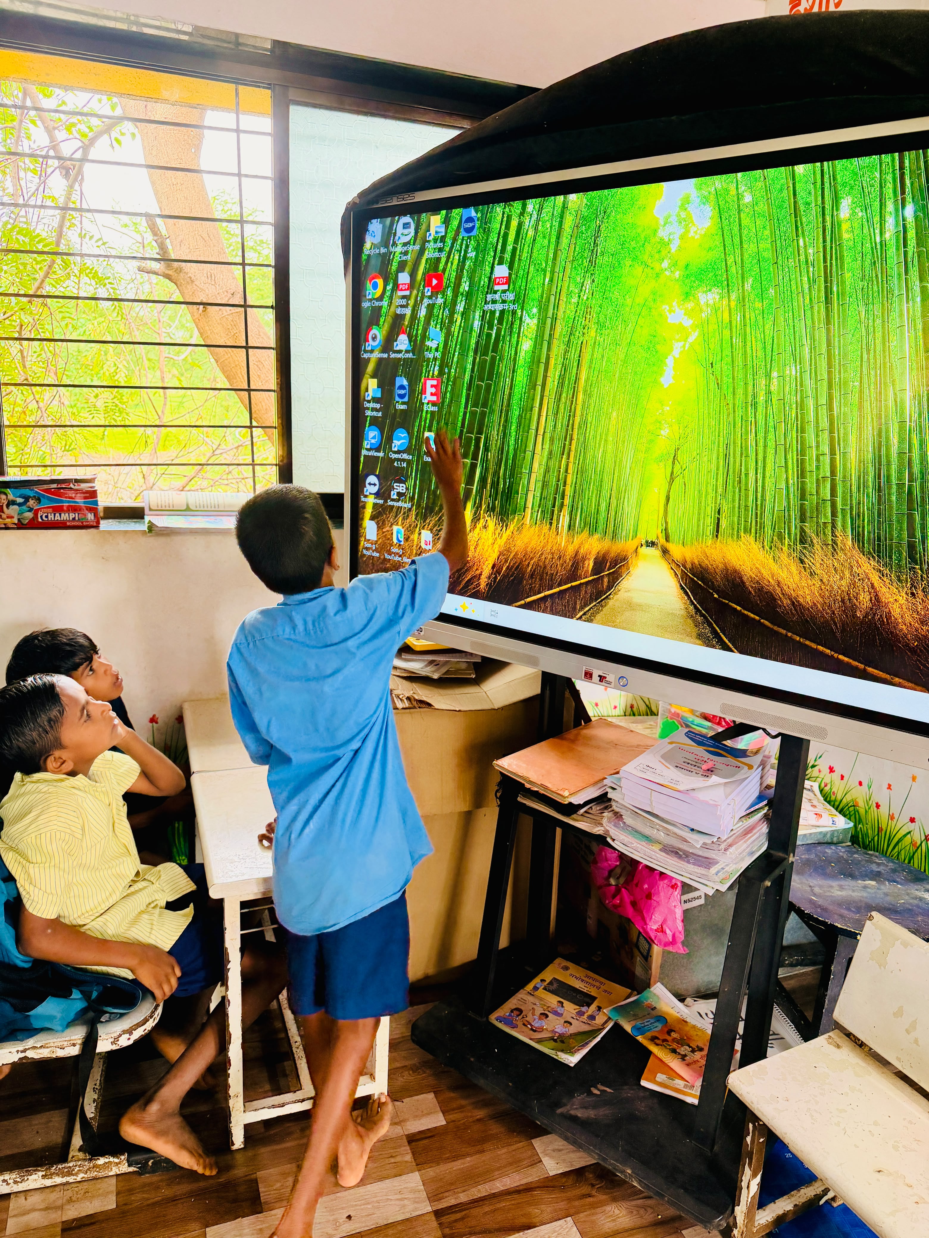 Schoolchildren using an interactive classroom display